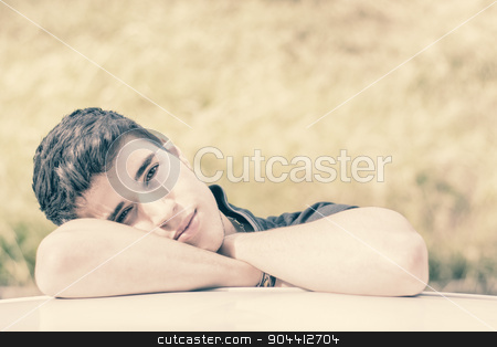 To use this stock image in your creative project, please select the size you need over to the right and click the "Add to Cart" button.
Your downloaded image will come with the Cutcaster watermark removed so don’t worry about the watermark you see on this page. Young man looking at camera outdoor, leaning with head resting on hands stock photo, Head and arms shot of handsome attractive young man looking at camera outdoor, leaning on flat surface with head resting on hands by Stefano Cavoretto