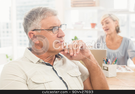 To use this stock image in your creative project, please select the size you need over to the right and click the "Add to Cart" button.
Your downloaded image will come with the Cutcaster watermark removed so don’t worry about the watermark you see on this page. Thoughtful businessman working at office stock photo, Close up view of a thoughtful businessman working at office by Wavebreak Media