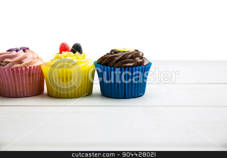 To use this stock image in your creative project, please select the size you need over to the right and click the "Add to Cart" button.
Your downloaded image will come with the Cutcaster watermark removed so don’t worry about the watermark you see on this page. Delicious cupcakes on a table stock photo, Delicious cupcakes on a table shot in studio by Wavebreak Media