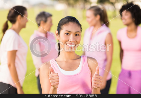 To use this stock image in your creative project, please select the size you need over to the right and click the "Add to Cart" button.
Your downloaded image will come with the Cutcaster watermark removed so don’t worry about the watermark you see on this page. Smiling woman wearing pink for breast cancer in front of friends stock photo, Portrait of smiling woman wearing pink for breast cancer in front of friends by Wavebreak Media