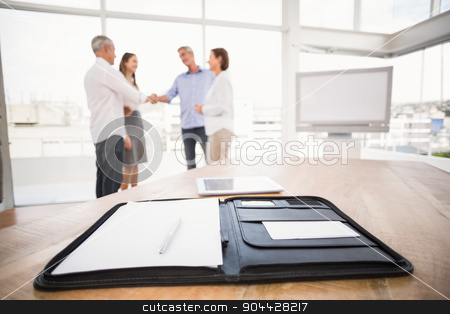 To use this stock image in your creative project, please select the size you need over to the right and click the "Add to Cart" button.
Your downloaded image will come with the Cutcaster watermark removed so don’t worry about the watermark you see on this page. Planner in front of handshaking business people stock photo, Planner in front of handshaking business people in the office by Wavebreak Media