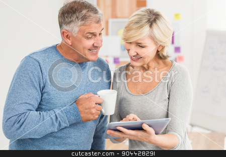 To use this stock image in your creative project, please select the size you need over to the right and click the "Add to Cart" button.
Your downloaded image will come with the Cutcaster watermark removed so don’t worry about the watermark you see on this page. Smiling business colleagues working on a tablet stock photo, Smiling business colleagues working on a tablet at the office by Wavebreak Media