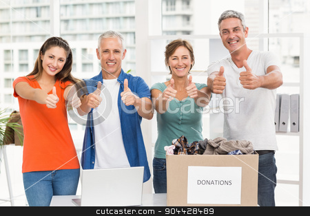 To use this stock image in your creative project, please select the size you need over to the right and click the "Add to Cart" button.
Your downloaded image will come with the Cutcaster watermark removed so don’t worry about the watermark you see on this page. Casual business people donating and doing thumbs up stock photo, Portrait of casual business people donating and doing thumbs up in the office by Wavebreak Media