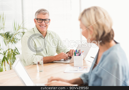 To use this stock image in your creative project, please select the size you need over to the right and click the "Add to Cart" button.
Your downloaded image will come with the Cutcaster watermark removed so don’t worry about the watermark you see on this page. Smiling business team working on laptops stock photo, Portrait of a smiling business team working on laptops at the office by Wavebreak Media