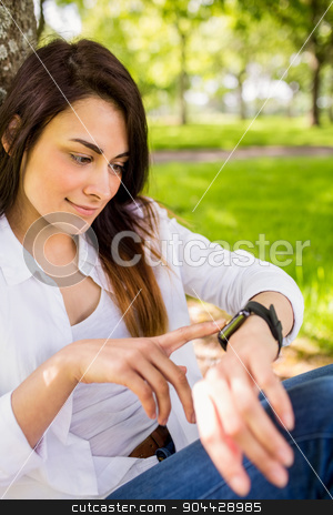 To use this stock image in your creative project, please select the size you need over to the right and click the "Add to Cart" button.
Your downloaded image will come with the Cutcaster watermark removed so don’t worry about the watermark you see on this page. Beautiful brunette using smartwatch in the park stock photo, Beautiful brunette using smartwatch in the park on a sunny day by Wavebreak Media