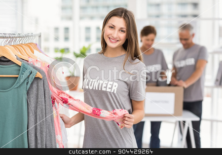 To use this stock image in your creative project, please select the size you need over to the right and click the "Add to Cart" button.
Your downloaded image will come with the Cutcaster watermark removed so don’t worry about the watermark you see on this page. Smiling female volunteer choosing clothes stock photo, Portrait of smiling female volunteer choosing clothes in the office by Wavebreak Media