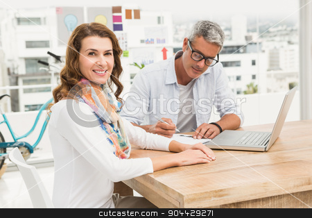 To use this stock image in your creative project, please select the size you need over to the right and click the "Add to Cart" button.
Your downloaded image will come with the Cutcaster watermark removed so don’t worry about the watermark you see on this page. Smiling casual designer in front of her working colleague stock photo, Portrait of smiling casual designer in front of her working colleague in the office by Wavebreak Media