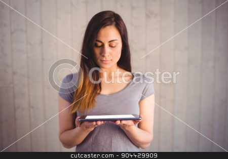 To use this stock image in your creative project, please select the size you need over to the right and click the "Add to Cart" button.
Your downloaded image will come with the Cutcaster watermark removed so don’t worry about the watermark you see on this page. Pretty brunette holding tablet pc stock photo, Pretty brunette holding tablet pc on wooden planks background by Wavebreak Media
