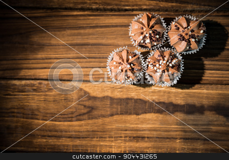 To use this stock image in your creative project, please select the size you need over to the right and click the "Add to Cart" button.
Your downloaded image will come with the Cutcaster watermark removed so don’t worry about the watermark you see on this page. Chocolate cupcakes on a table stock photo, Chocolate cupcakes on a table shot in studio by Wavebreak Media