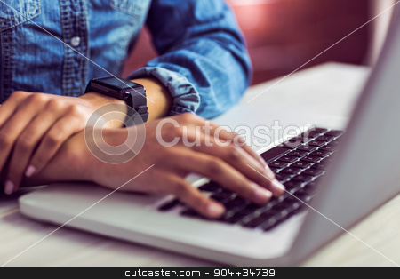 To use this stock image in your creative project, please select the size you need over to the right and click the "Add to Cart" button.
Your downloaded image will come with the Cutcaster watermark removed so don’t worry about the watermark you see on this page. Casual businesswoman using laptop and smartwatch stock photo, Casual businesswoman using laptop and smartwatch in her office by Wavebreak Media