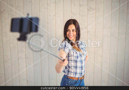 To use this stock image in your creative project, please select the size you need over to the right and click the "Add to Cart" button.
Your downloaded image will come with the Cutcaster watermark removed so don’t worry about the watermark you see on this page. Pretty hipster taking a selfie with stick stock photo, Pretty hipster taking a selfie with stick on wooden planks background by Wavebreak Media