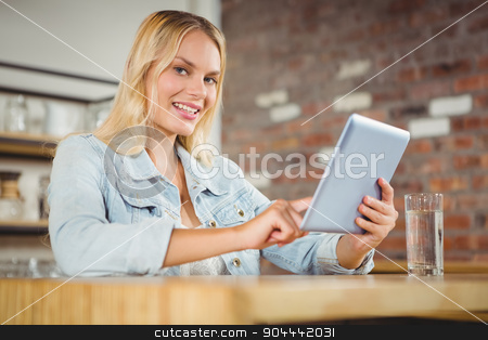 To use this stock image in your creative project, please select the size you need over to the right and click the "Add to Cart" button.
Your downloaded image will come with the Cutcaster watermark removed so don’t worry about the watermark you see on this page. Smiling blonde touching on tablet computer stock photo, Smiling blonde touching on tablet computer at coffee shop by Wavebreak Media