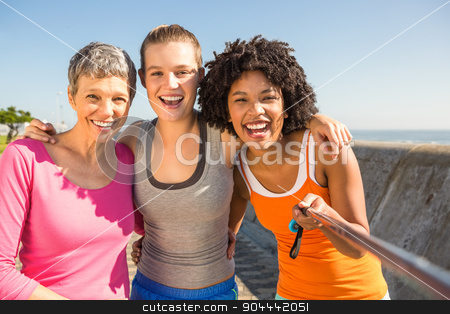 To use this stock image in your creative project, please select the size you need over to the right and click the "Add to Cart" button.
Your downloaded image will come with the Cutcaster watermark removed so don’t worry about the watermark you see on this page. Smiling sporty women taking selfies with selfiestick stock photo, Portrait of smiling sporty women taking selfies with selfiestick at promenade by Wavebreak Media