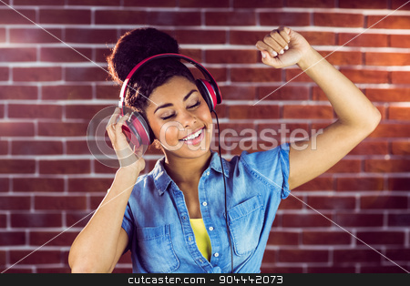 To use this stock image in your creative project, please select the size you need over to the right and click the "Add to Cart" button.
Your downloaded image will come with the Cutcaster watermark removed so don’t worry about the watermark you see on this page. A smiling woman dancing with headphones stock photo, A smiling woman dancing with headphones on a brick wall by Wavebreak Media
