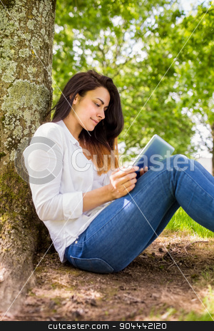 To use this stock image in your creative project, please select the size you need over to the right and click the "Add to Cart" button.
Your downloaded image will come with the Cutcaster watermark removed so don’t worry about the watermark you see on this page. Beautiful brunette using tablet pc in the park stock photo, Beautiful brunette using tablet pc in the park on a sunny day by Wavebreak Media