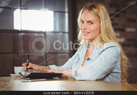 To use this stock image in your creative project, please select the size you need over to the right and click the "Add to Cart" button.
Your downloaded image will come with the Cutcaster watermark removed so don’t worry about the watermark you see on this page. Smiling blonde having coffee and writing in planner stock photo, Portrait of smiling blonde having coffee and writing in planner at coffee shop by Wavebreak Media