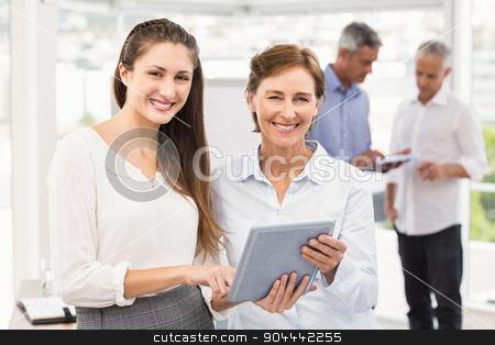 To use this stock image in your creative project, please select the size you need over to the right and click the "Add to Cart" button.
Your downloaded image will come with the Cutcaster watermark removed so don’t worry about the watermark you see on this page. Smiling businesswomen using tablet in a meeting stock photo, Portrait of smiling businesswomen using tablet in a meeting in the office by Wavebreak Media