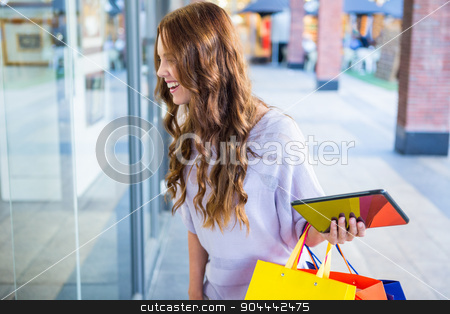 To use this stock image in your creative project, please select the size you need over to the right and click the "Add to Cart" button.
Your downloaded image will come with the Cutcaster watermark removed so don’t worry about the watermark you see on this page. Pretty woman shopping at the mall using tablet stock photo, Pretty woman shopping at the mall using tablet on a sunny day by Wavebreak Media