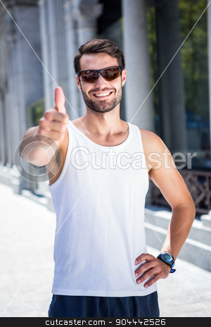 To use this stock image in your creative project, please select the size you need over to the right and click the "Add to Cart" button.
Your downloaded image will come with the Cutcaster watermark removed so don’t worry about the watermark you see on this page. Smiling handsome athlete doing thumbs up stock photo, Portrait of smiling handsome athlete doing thumbs up in the city by Wavebreak Media