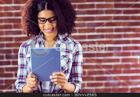 To use this stock image in your creative project, please select the size you need over to the right and click the "Add to Cart" button.
Your downloaded image will come with the Cutcaster watermark removed so don’t worry about the watermark you see on this page. Attractive hipster smiling and looking at tablet stock photo, Attractive hipster smiling and looking at tablet against red brick background by Wavebreak Media