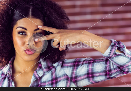 To use this stock image in your creative project, please select the size you need over to the right and click the "Add to Cart" button.
Your downloaded image will come with the Cutcaster watermark removed so don’t worry about the watermark you see on this page. Attractive young woman showing peace sign stock photo, Portrait of attractive young woman showing peace sign against red brick background by Wavebreak Media