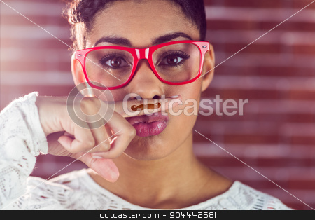 To use this stock image in your creative project, please select the size you need over to the right and click the "Add to Cart" button.
Your downloaded image will come with the Cutcaster watermark removed so don’t worry about the watermark you see on this page. Portrait of a happy hipster wearing a fake mustache stock photo, Portrait of a happy hipster wearing a fake mustache on her finger by Wavebreak Media