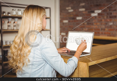 To use this stock image in your creative project, please select the size you need over to the right and click the "Add to Cart" button.
Your downloaded image will come with the Cutcaster watermark removed so don’t worry about the watermark you see on this page. Rear view of blonde having coffee and using laptop stock photo, Rear view of blonde having coffee and using laptop at coffee shop by Wavebreak Media
