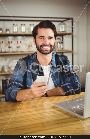 To use this stock image in your creative project, please select the size you need over to the right and click the "Add to Cart" button.
Your downloaded image will come with the Cutcaster watermark removed so don’t worry about the watermark you see on this page. Young student enjoying a coffee and using his smartphone stock photo, Young student enjoying a coffee and using his smartphone in a cafe by Wavebreak Media