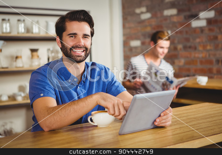 To use this stock image in your creative project, please select the size you need over to the right and click the "Add to Cart" button.
Your downloaded image will come with the Cutcaster watermark removed so don’t worry about the watermark you see on this page. Young man having cup of coffee using tablet stock photo, Young man having cup of coffee using tablet at the cafe by Wavebreak Media
