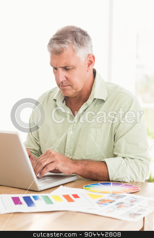 To use this stock image in your creative project, please select the size you need over to the right and click the "Add to Cart" button.
Your downloaded image will come with the Cutcaster watermark removed so don’t worry about the watermark you see on this page. Attentive businessman working on a laptop stock photo, Attentive businessman working on a laptop at the office by Wavebreak Media