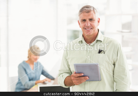 To use this stock image in your creative project, please select the size you need over to the right and click the "Add to Cart" button.
Your downloaded image will come with the Cutcaster watermark removed so don’t worry about the watermark you see on this page. Standing smiling businessman looking at the camera stock photo, Portrait of a standing businessman holding a tablet at the office by Wavebreak Media
