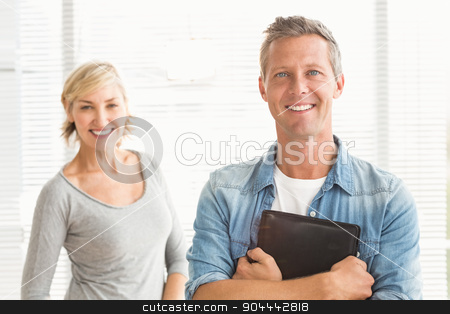 To use this stock image in your creative project, please select the size you need over to the right and click the "Add to Cart" button.
Your downloaded image will come with the Cutcaster watermark removed so don’t worry about the watermark you see on this page. Smiling business colleagues holding a tablet stock photo, Portrait of two business colleagues holding a tablet at office by Wavebreak Media
