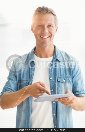 To use this stock image in your creative project, please select the size you need over to the right and click the "Add to Cart" button.
Your downloaded image will come with the Cutcaster watermark removed so don’t worry about the watermark you see on this page. Smiling businessman scrolling on a tablet stock photo, Portrait of a smiling businessman scrolling on a tablet at office by Wavebreak Media