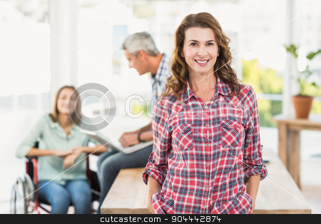 To use this stock image in your creative project, please select the size you need over to the right and click the "Add to Cart" button.
Your downloaded image will come with the Cutcaster watermark removed so don’t worry about the watermark you see on this page. Casual female artist with colleagues in background at office stock photo, Portrait of a casual female artist with colleagues in the background at a bright office by Wavebreak Media