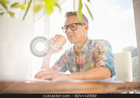To use this stock image in your creative project, please select the size you need over to the right and click the "Add to Cart" button.
Your downloaded image will come with the Cutcaster watermark removed so don’t worry about the watermark you see on this page. Casual designer drinking out of take-away cup stock photo, Casual designer drinking out of take-away cup in the office by Wavebreak Media