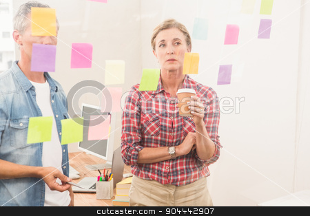 To use this stock image in your creative project, please select the size you need over to the right and click the "Add to Cart" button.
Your downloaded image will come with the Cutcaster watermark removed so don’t worry about the watermark you see on this page. Casual business colleagues working with sticky notes stock photo, Casual business colleagues working with sticky notes in the office by Wavebreak Media