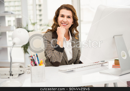 To use this stock image in your creative project, please select the size you need over to the right and click the "Add to Cart" button.
Your downloaded image will come with the Cutcaster watermark removed so don’t worry about the watermark you see on this page. Smiling casual businesswoman working at desk stock photo, Portrait of smiling casual businesswoman working at desk in the office by Wavebreak Media