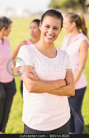 To use this stock image in your creative project, please select the size you need over to the right and click the "Add to Cart" button.
Your downloaded image will come with the Cutcaster watermark removed so don’t worry about the watermark you see on this page. Smiling brunette wearing pink for breast cancer in front of frie stock photo, Portrait of smiling brunette wearing pink for breast cancer in front of friends in parkland by Wavebreak Media