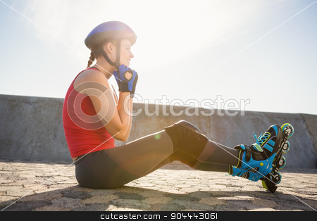To use this stock image in your creative project, please select the size you need over to the right and click the "Add to Cart" button.
Your downloaded image will come with the Cutcaster watermark removed so don’t worry about the watermark you see on this page. Sporty blonde skater sitting on ground and fastening helmet stock photo, Sporty blonde skater sitting on ground and fastening helmet at promenade by Wavebreak Media