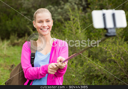 To use this stock image in your creative project, please select the size you need over to the right and click the "Add to Cart" button.
Your downloaded image will come with the Cutcaster watermark removed so don’t worry about the watermark you see on this page. Smiling female hiker taking a selfie stock photo, Smiling female hiker taking a selfie with a selfie stick in the nature by Wavebreak Media