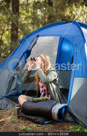 To use this stock image in your creative project, please select the size you need over to the right and click the "Add to Cart" button.
Your downloaded image will come with the Cutcaster watermark removed so don’t worry about the watermark you see on this page. Blonde camper looking through binoculars stock photo, Blonde camper looking through binoculars while sitting in tent by Wavebreak Media