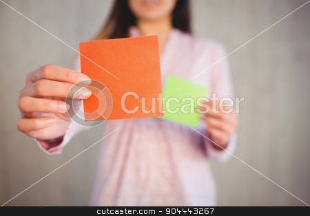 To use this stock image in your creative project, please select the size you need over to the right and click the "Add to Cart" button.
Your downloaded image will come with the Cutcaster watermark removed so don’t worry about the watermark you see on this page. Woman holding green and orange cards stock photo, Woman holding green and orange cards on wooden planks background by Wavebreak Media