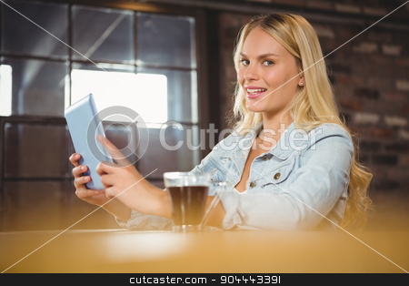 To use this stock image in your creative project, please select the size you need over to the right and click the "Add to Cart" button.
Your downloaded image will come with the Cutcaster watermark removed so don’t worry about the watermark you see on this page. Smiling blonde having coffee and using tablet computer stock photo, Smiling blonde having coffee and using tablet computer at coffee shop by Wavebreak Media