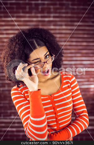 To use this stock image in your creative project, please select the size you need over to the right and click the "Add to Cart" button.
Your downloaded image will come with the Cutcaster watermark removed so don’t worry about the watermark you see on this page. Attractive young woman winking stock photo, Portrait of attractive young woman winking against red brick background by Wavebreak Media