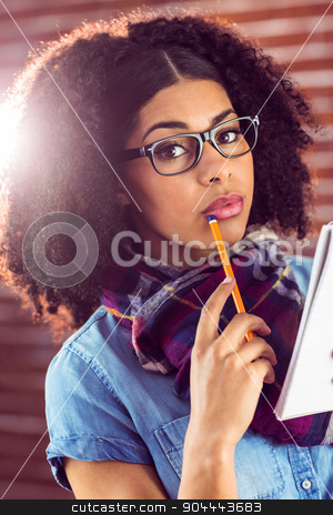 To use this stock image in your creative project, please select the size you need over to the right and click the "Add to Cart" button.
Your downloaded image will come with the Cutcaster watermark removed so don’t worry about the watermark you see on this page. Attractive focused hipster taking notes stock photo, Portrait of attractive focused hipster taking notes against red brick background by Wavebreak Media