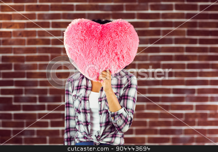 To use this stock image in your creative project, please select the size you need over to the right and click the "Add to Cart" button.
Your downloaded image will come with the Cutcaster watermark removed so don’t worry about the watermark you see on this page. Young woman holding up heart-shaped pillow stock photo, Young woman holding up heart-shaped pillow against red brick background by Wavebreak Media