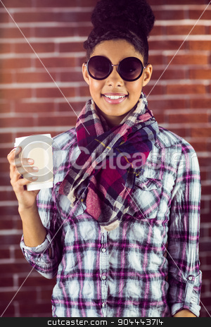 To use this stock image in your creative project, please select the size you need over to the right and click the "Add to Cart" button.
Your downloaded image will come with the Cutcaster watermark removed so don’t worry about the watermark you see on this page. A female hipster holding a cup of coffee stock photo, A female hipster holding a cup of coffee against a brick wall by Wavebreak Media