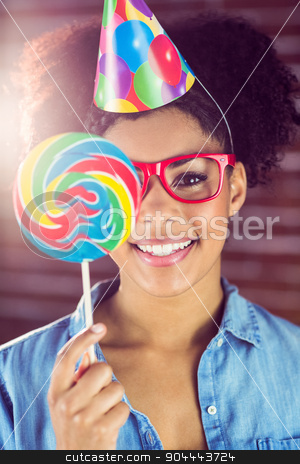 To use this stock image in your creative project, please select the size you need over to the right and click the "Add to Cart" button.
Your downloaded image will come with the Cutcaster watermark removed so don’t worry about the watermark you see on this page. Portrait of a hipster hiding herself behind a lollipop stock photo, Portrait of a hipster hiding herself behind a lollipop against a brick wall by Wavebreak Media