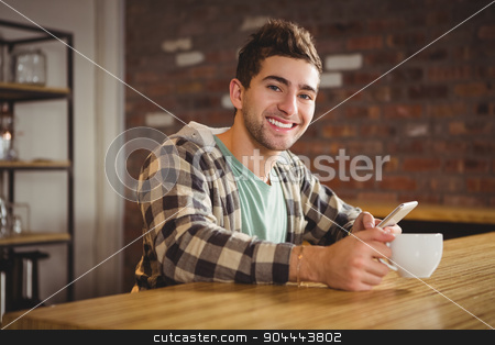 To use this stock image in your creative project, please select the size you need over to the right and click the "Add to Cart" button.
Your downloaded image will come with the Cutcaster watermark removed so don’t worry about the watermark you see on this page. Smiling hipster drinking coffee and using smartphone stock photo, Portrait of smiling hipster drinking coffee and using smartphone at coffee shop by Wavebreak Media
