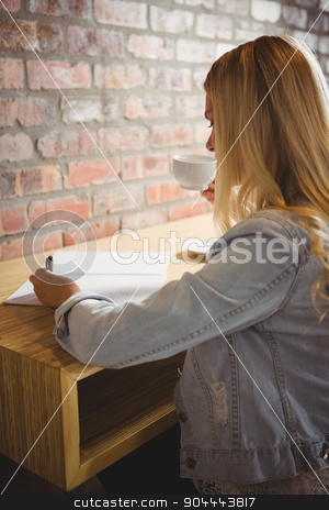 To use this stock image in your creative project, please select the size you need over to the right and click the "Add to Cart" button.
Your downloaded image will come with the Cutcaster watermark removed so don’t worry about the watermark you see on this page. Smiling blonde drinking coffee and writing on sheet of paper stock photo, Smiling blonde drinking coffee and writing on sheet of paper at coffee shop by Wavebreak Media
